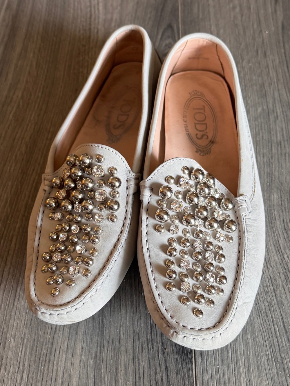 white leather loafers by Tod's featuring metallic bubble embellishments
